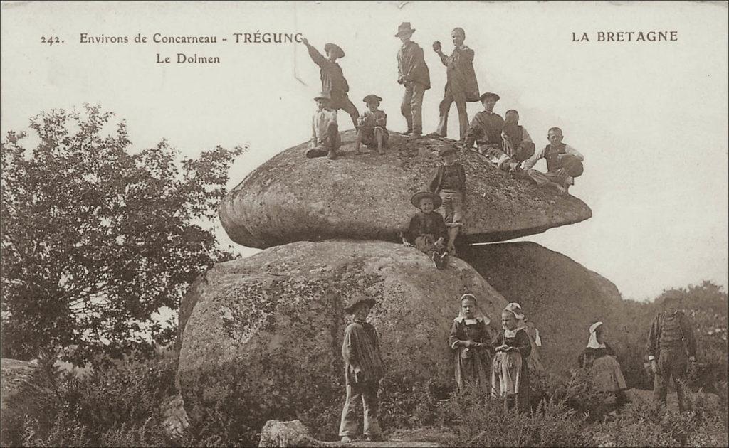 Un groupe d'enfants jouant sur le dolmen de Trégunc au début des années 1900.